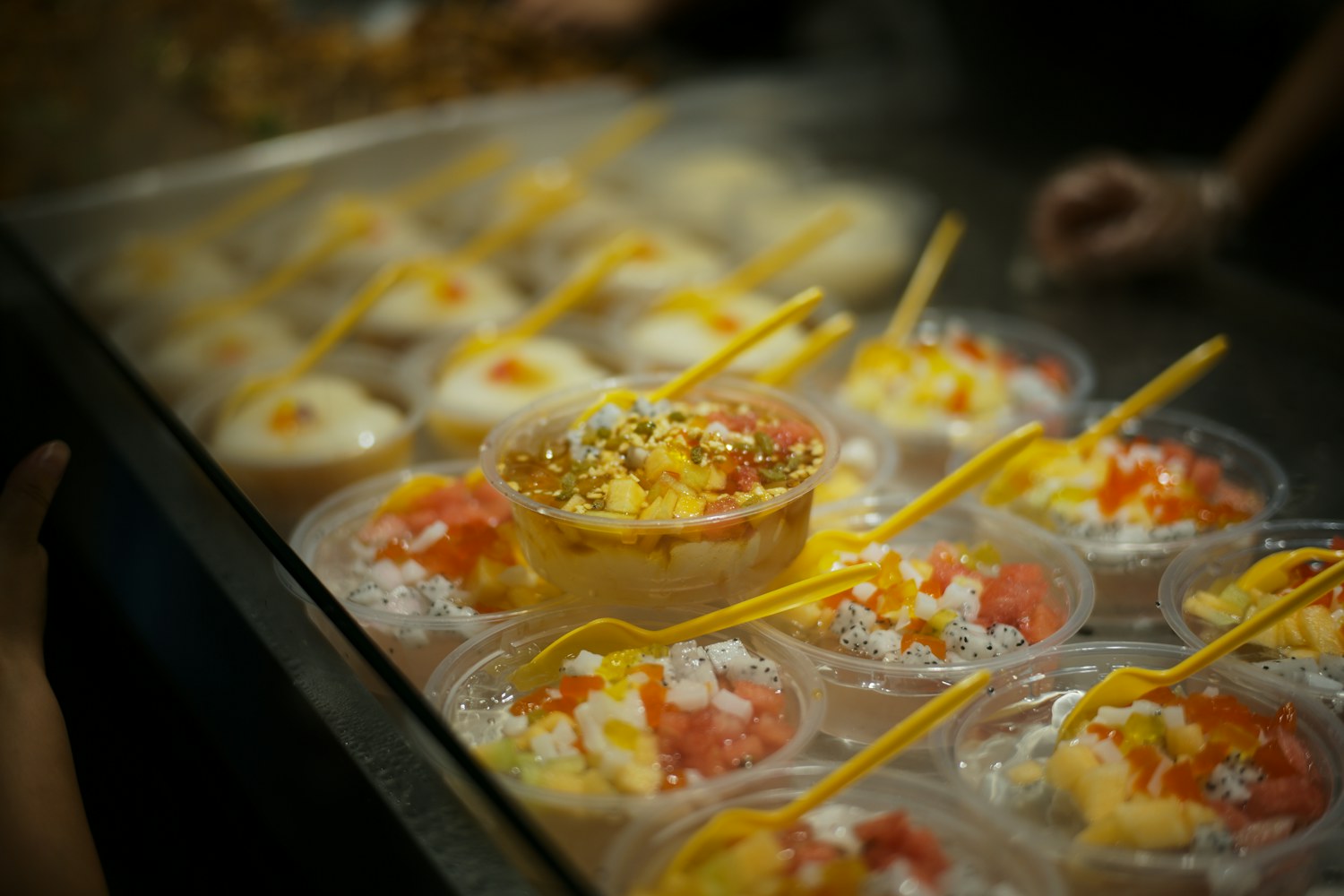 Rolled ice cream in a cup with fruit topping