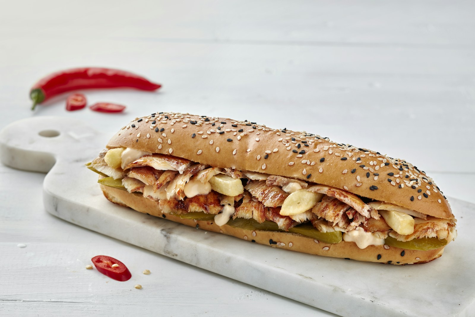 Grilled chicken and melted cheese in a long seeded roll