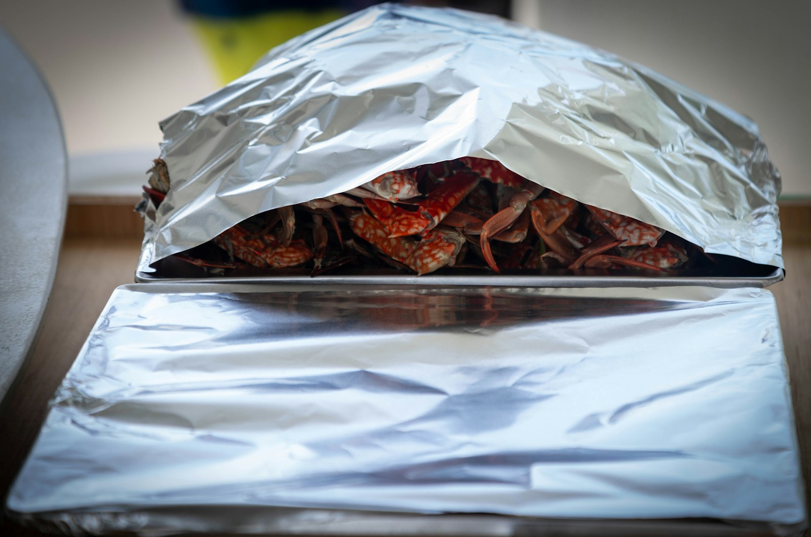 Leftover food covered with foil on a tray