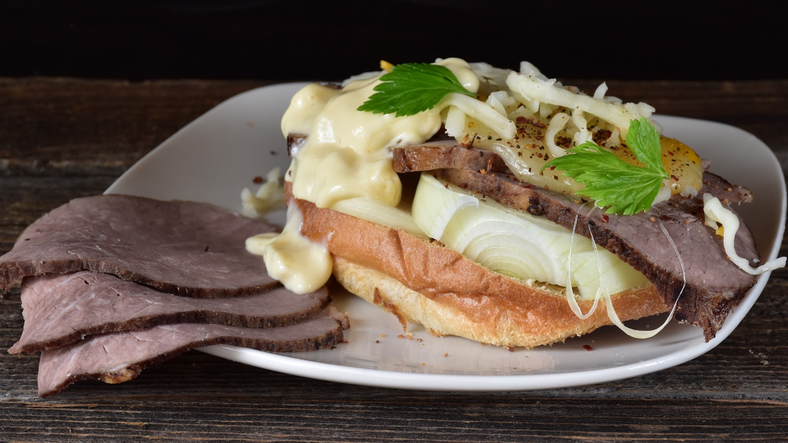 Sliced roast beef and melted cheese in a long split roll