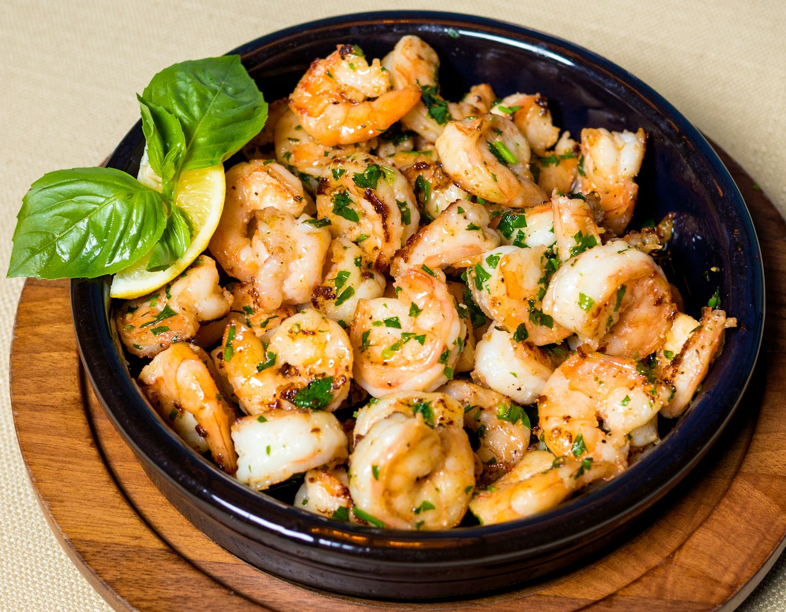 Garlic shrimp served in a bowl with lemon