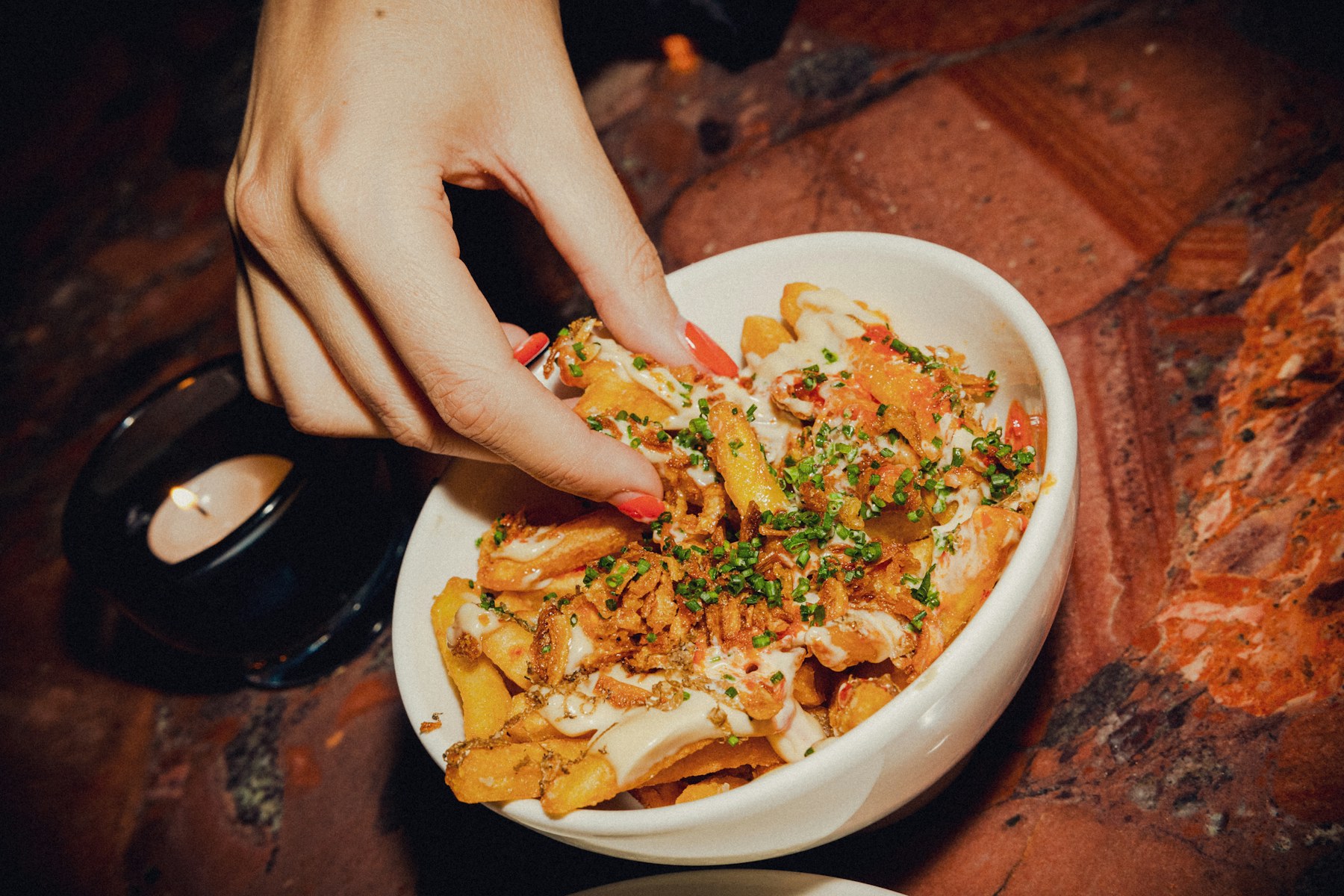 Loaded fries topped with cheese and herbs