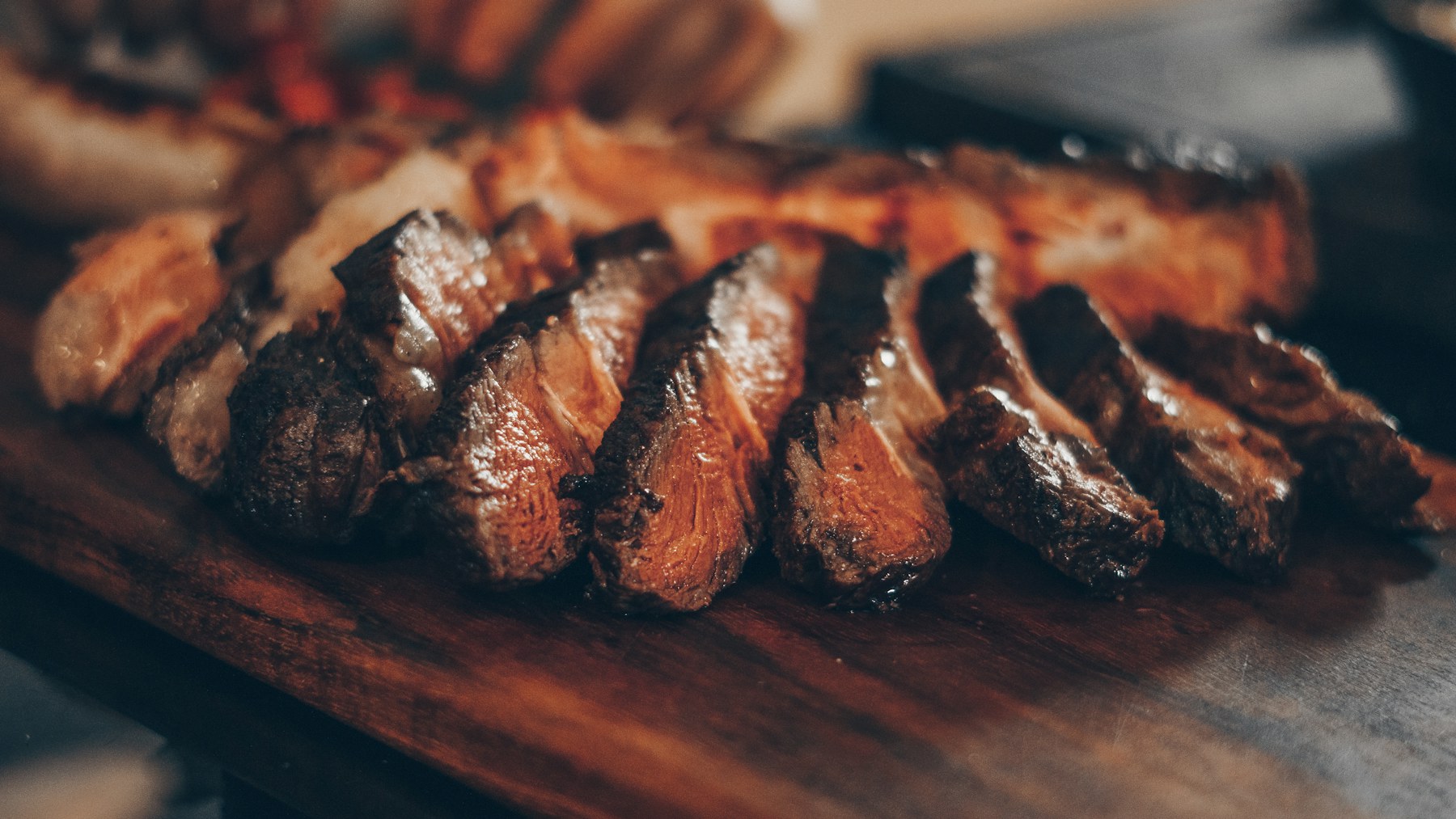 Sliced ribeye resting on a carving board